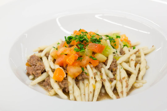 Pasta Strozzapreti with meat sauce and vegetables