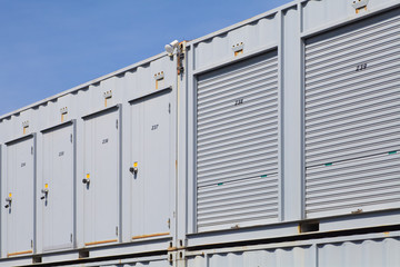 Fototapeta na wymiar Exterior of white storage unit or small warehouse for rental