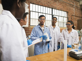 Students listening to teacher in science lab