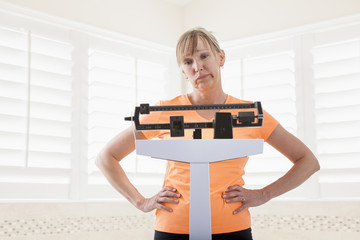 Caucasian woman weighing herself