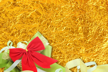 Shiny yellow leaf gold and  ribbon on Shiny foil texture backgro
