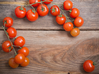 Fototapeta na wymiar cherry tomatoes on rustic wooden background