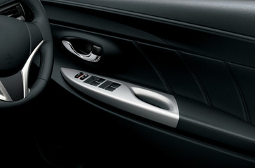 Obraz na płótnie Canvas Car interior detail. Closeup of controls on the door