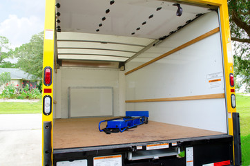Empty moving truck with dolly in back