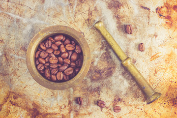 Coffee beans in a bronze mortar