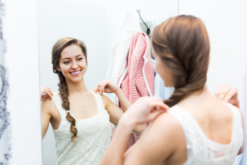 Girl at boutique changing cubicle.