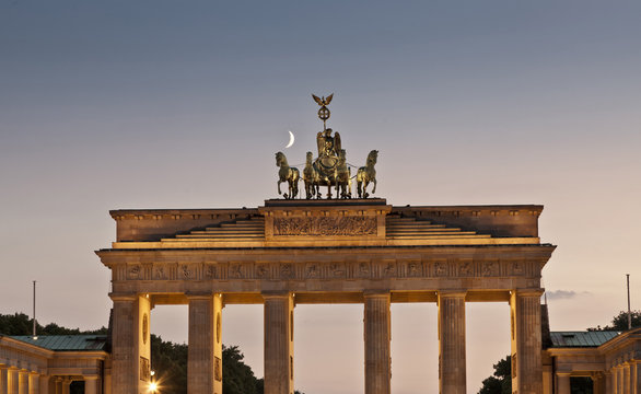 Columned building and statue lit up at night, Berlin, Germany