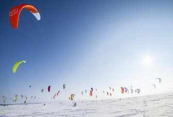 Kiteboarder with kite on the snow - Powered by Adobe