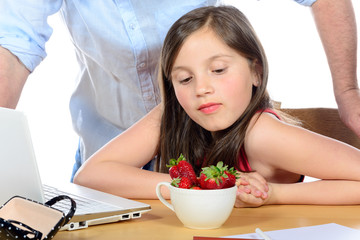 a little girl looking  the strawberries with envy