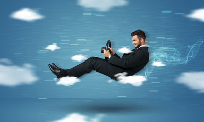 Funny racedriver young man driving between clouds concept