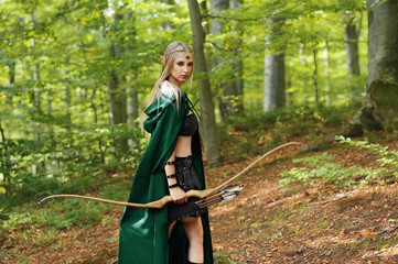 female elf with a bow in the forest