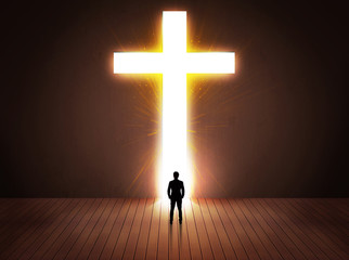 Man looking at bright cross sign