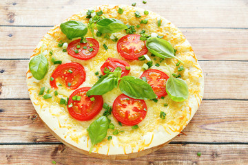 round pizza with mozzarella and tomatoes