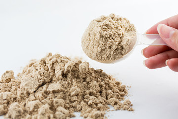 The hand raise a spoon measure Whey protein chocolate powder for