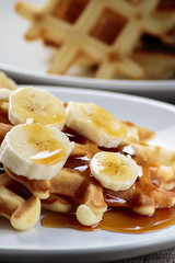 Waffles with bananas covered with maple syrup