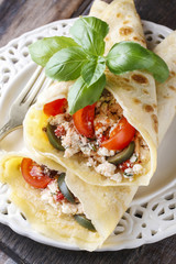 Mediterranean cuisine: crepes stuffed with cheese and vegetables