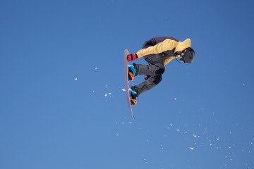 Snowboarder jumps in Snow Park