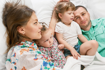 Happy mother and the father with cute daughters