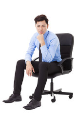 Young businessman sitting in a chair and thinking