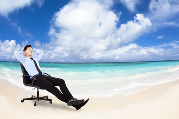 relaxed Young businessman sitting in  chair with beach backgrou