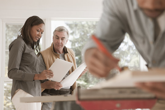 Man and woman looking at blueprints together