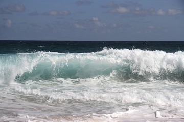 Wave crashing on tropical beach