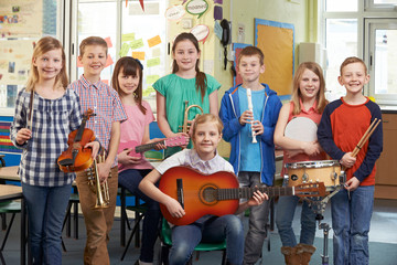 Portrait Of Students Playing In School Orchestra Together