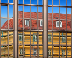 Old building architecture reflected in modern building