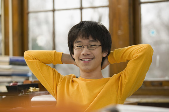 Asian student relaxing in classroom