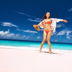 Woman with sarong on beach at Seychelles
