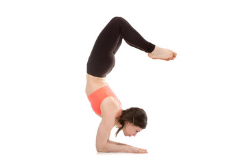 Yogi female in yoga Scorpion Pose Vrischikasana 1