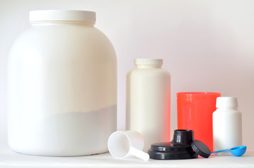 Big jar of protein powder, bottles and shaker
