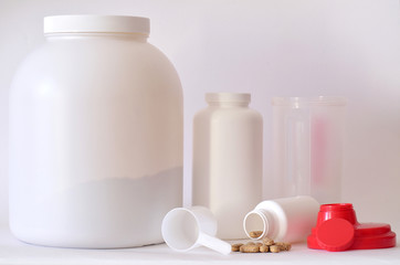 Big jar of protein powder, bottles and shaker