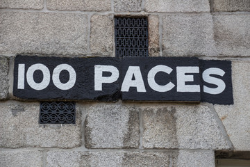 Sign "100 paces" at the Collins Barracks in Dublin, Ireland, 201