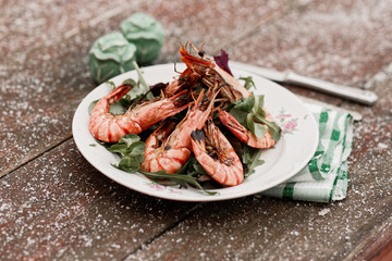 Grilled shrimps served outdoor in winter, toned image