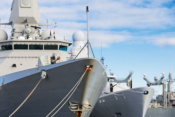 Close-up view of naval ships with guns.