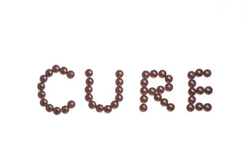 Cure written with brown pills