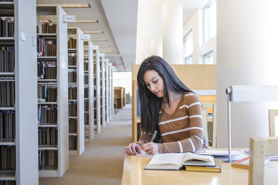 Student working at desk in library