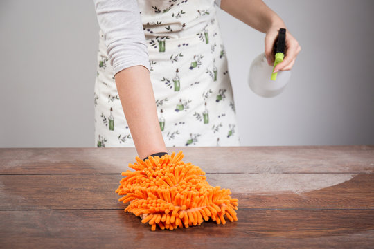 Woman Cleaning Dusty Wooden Desk