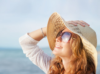 Happy woman relaxing at the beach. Summer vacations concept