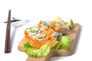 Set of California sushi rolls on a wooden board with chopsticks