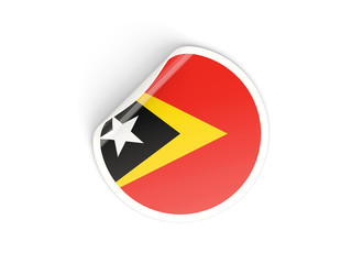 Naklejka premium Round sticker with flag of east timor