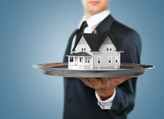 Architect. Real estate offer. Businessman holding a silver tray