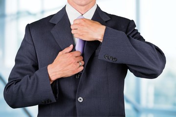 Suit. Checking the necktie