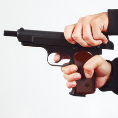 Hands reload semi-automatic gun on a white background