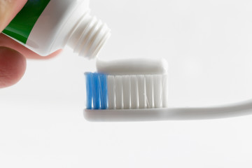 Fototapeta na wymiar Hand press Toothpaste on tooth brush.