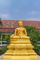 the gold buddha statue sitting under sunlight