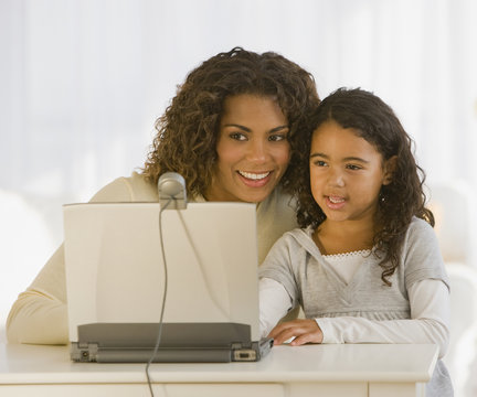 African Mother And Daughter Looking At Web Cam