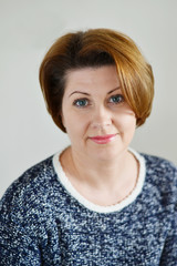 Fototapeta premium Portrait of the adult female on light background