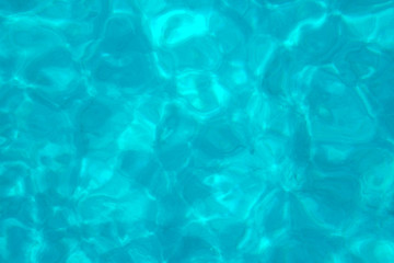 Background of clear natural blue water od a swimming pool